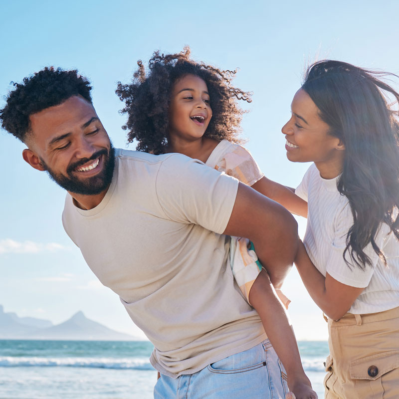 family smiling on beach
